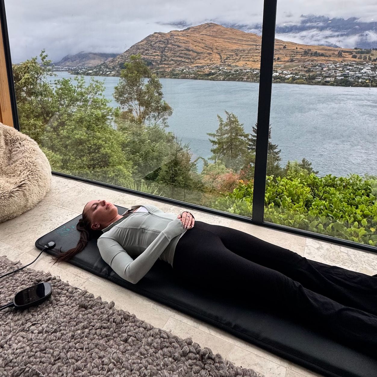 Emma laying on the full body pulsed electromagnetic field unit