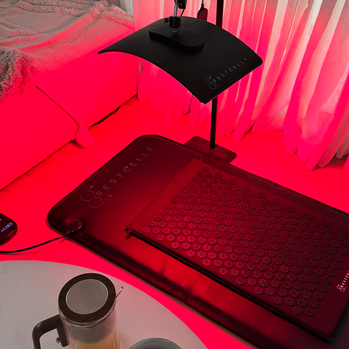 Wellness setup with PEMF mat, acupressure mat and red light.